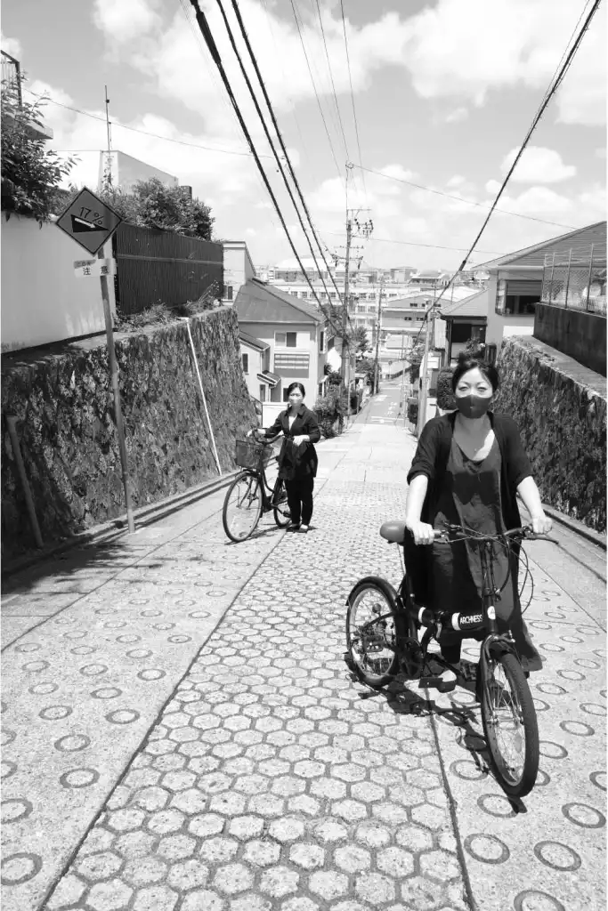 Two sisters are standing on a sloped pathway, demonstrating the commuter route in Chikusa-ku Nagoya.