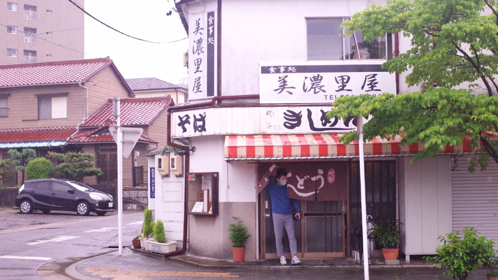 A man standing in front of a doorway at Minoriyam in Chikusa-ku, Nagoya