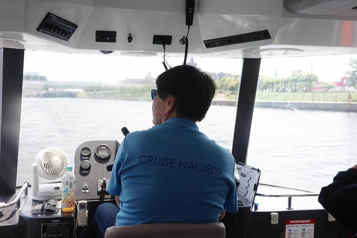 A captain steering the ship during the Nagoya cruise adventure.