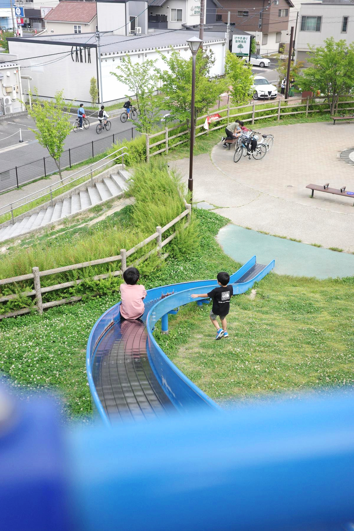 The children take turns on the slide.