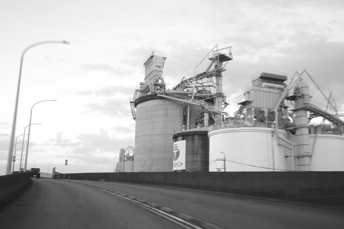 A looming factory dominating the landscape.