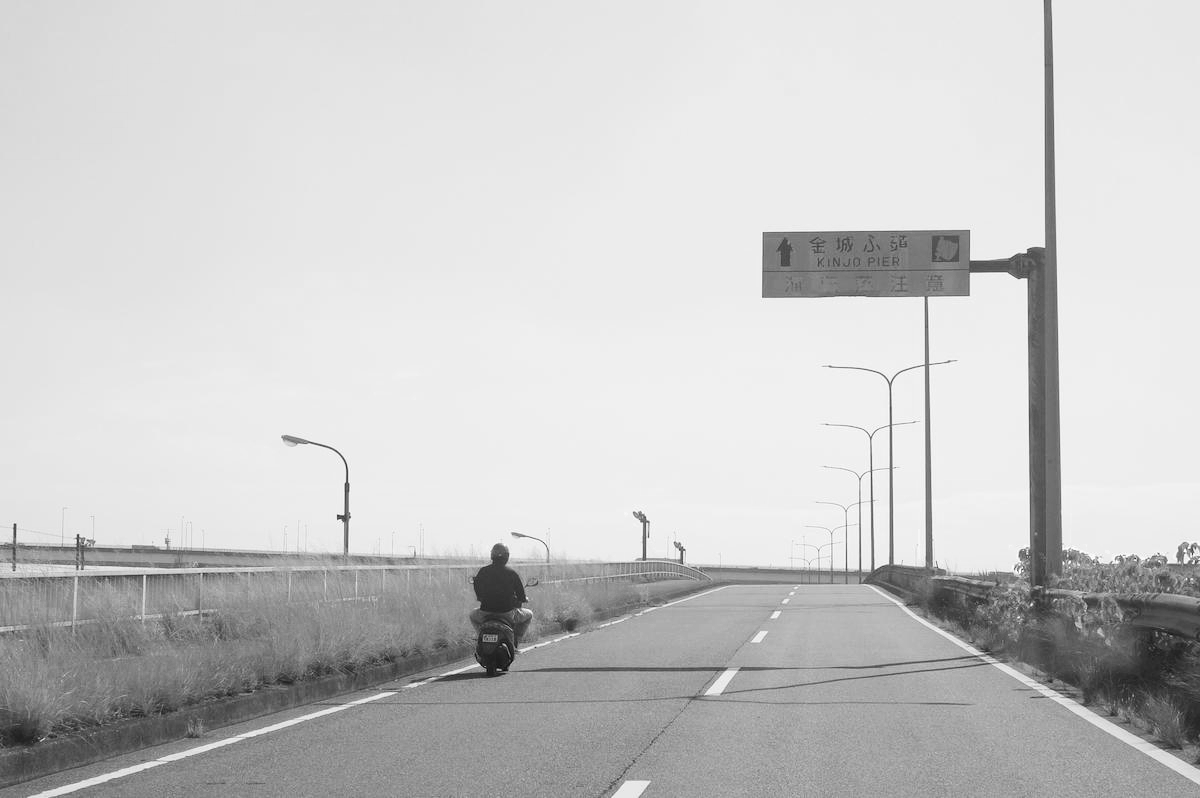 Heading towards Kinjo Pier by motorcycle.