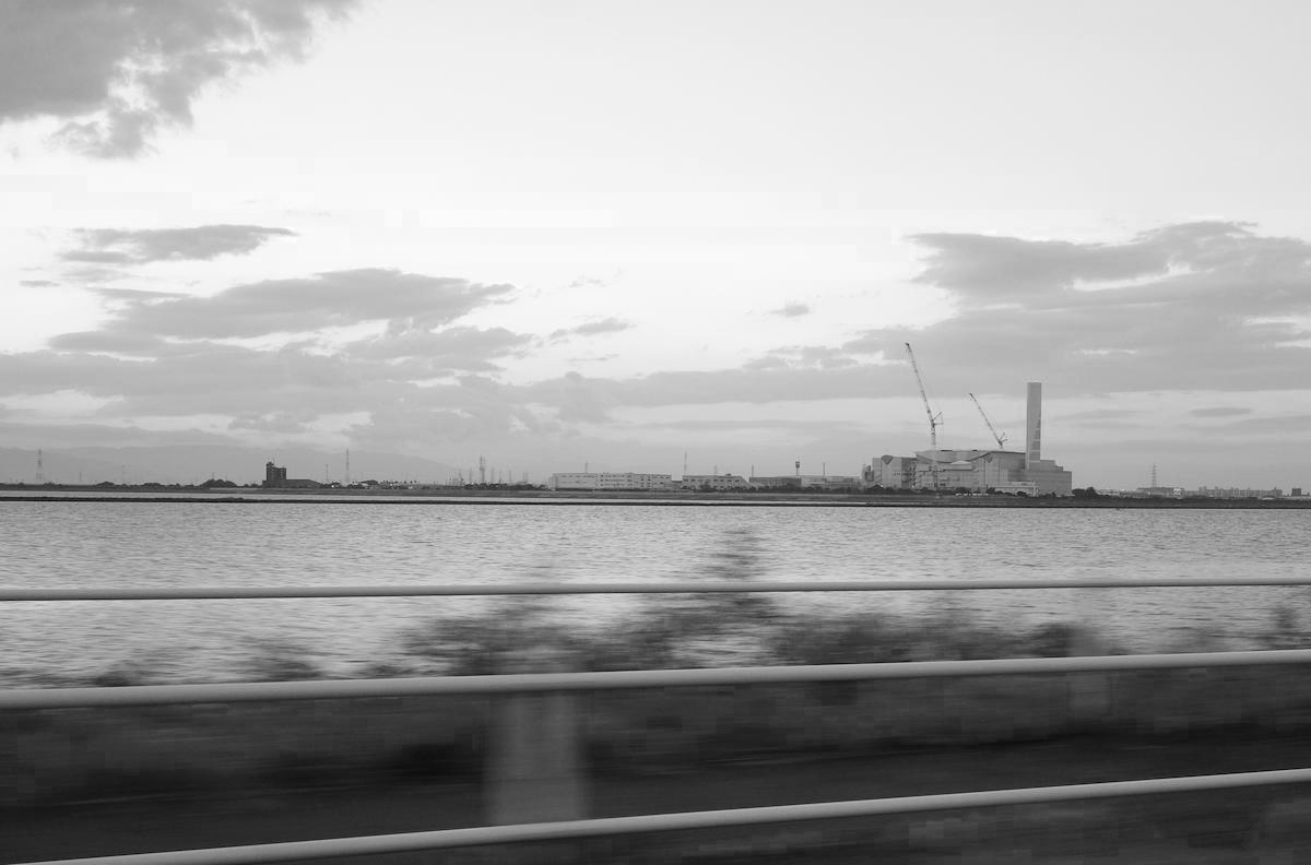 Sea, factories and tidal flats.