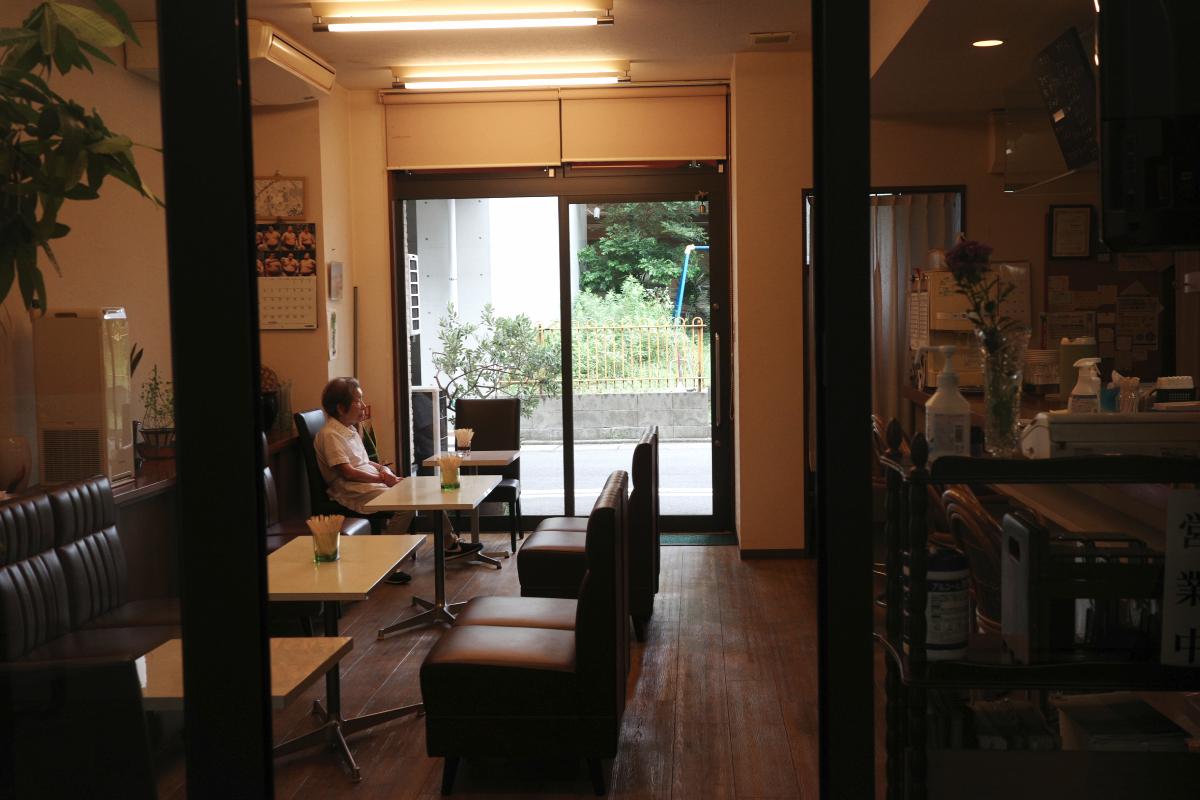 The owner sits quietly at her coffee shop.