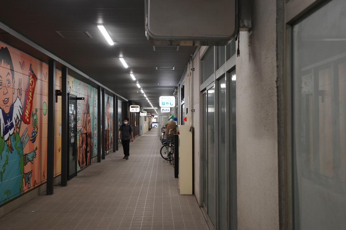 The student walking through the alley.