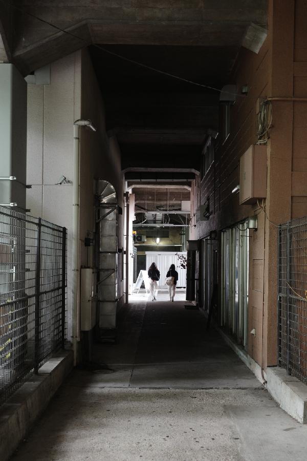 Two girls walks through to the South exit.