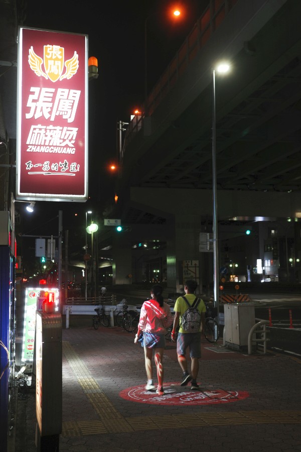 The couple walks past the restaurant, contemplating whether to have dinner there or not.