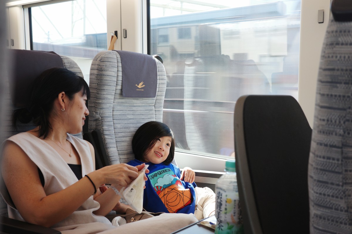 Family enjoys comfortable and family-friendly seating and vibes at Kintetsu Railway during Nagoya to Osaka.