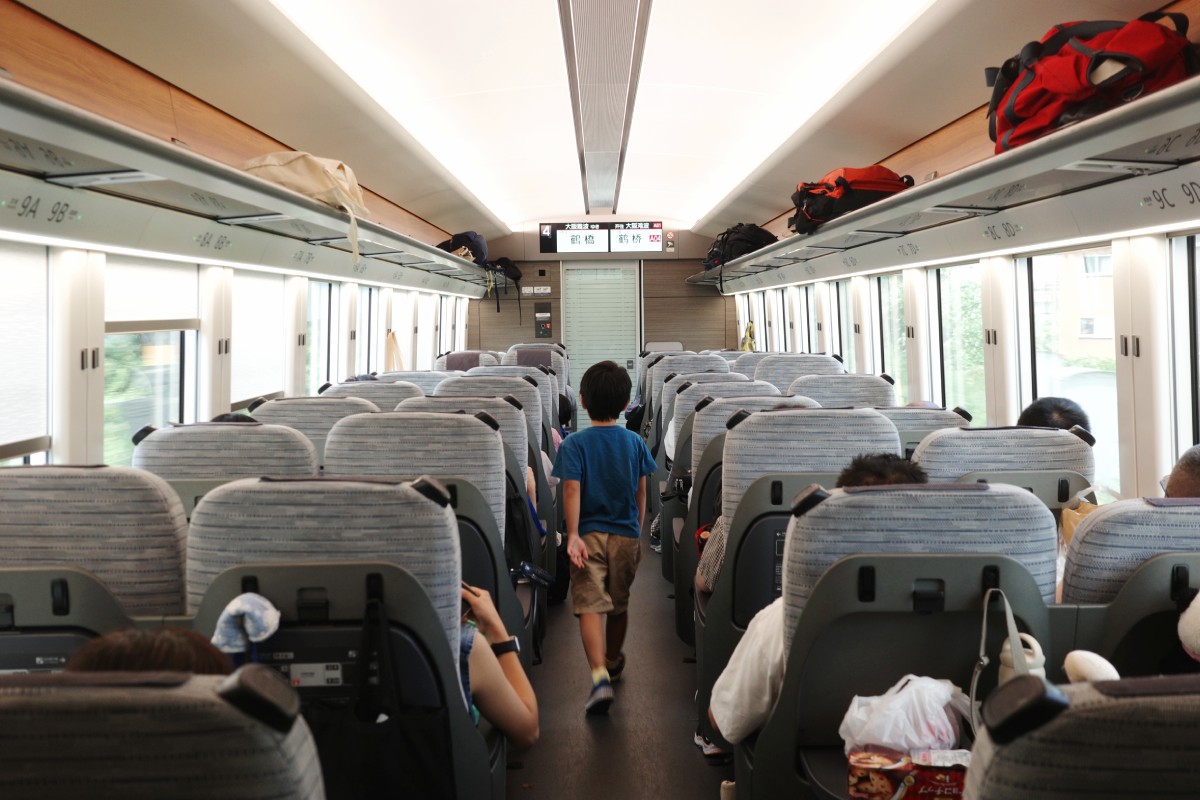 Child traveling on a train from Nagoya to Osaka by Kintetsu railway.