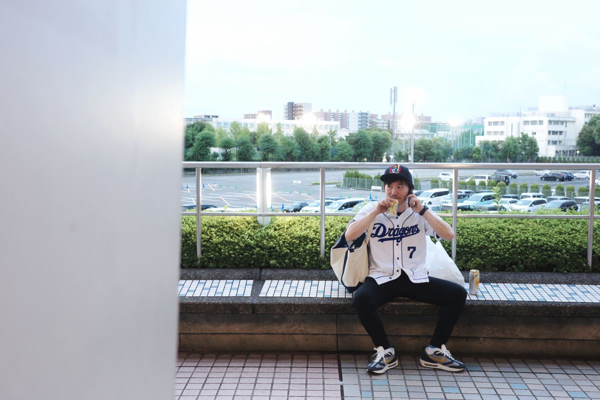 A man is enjoying a beer outside Vantelin Dome Nagoya before the game begins.