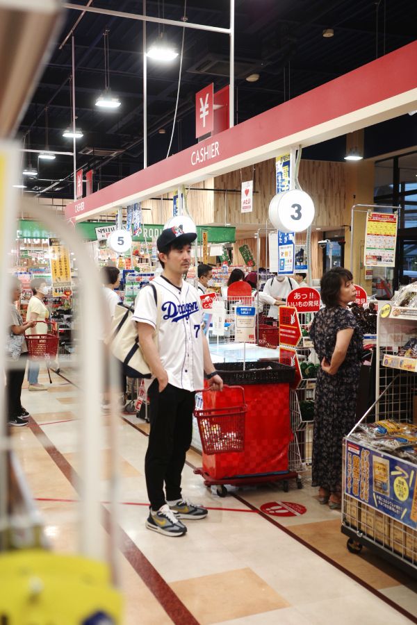 "A man goes shopping before the Chunichi Dragons baseball game begins at a supermarket near Vantelin Dome Nagoya.