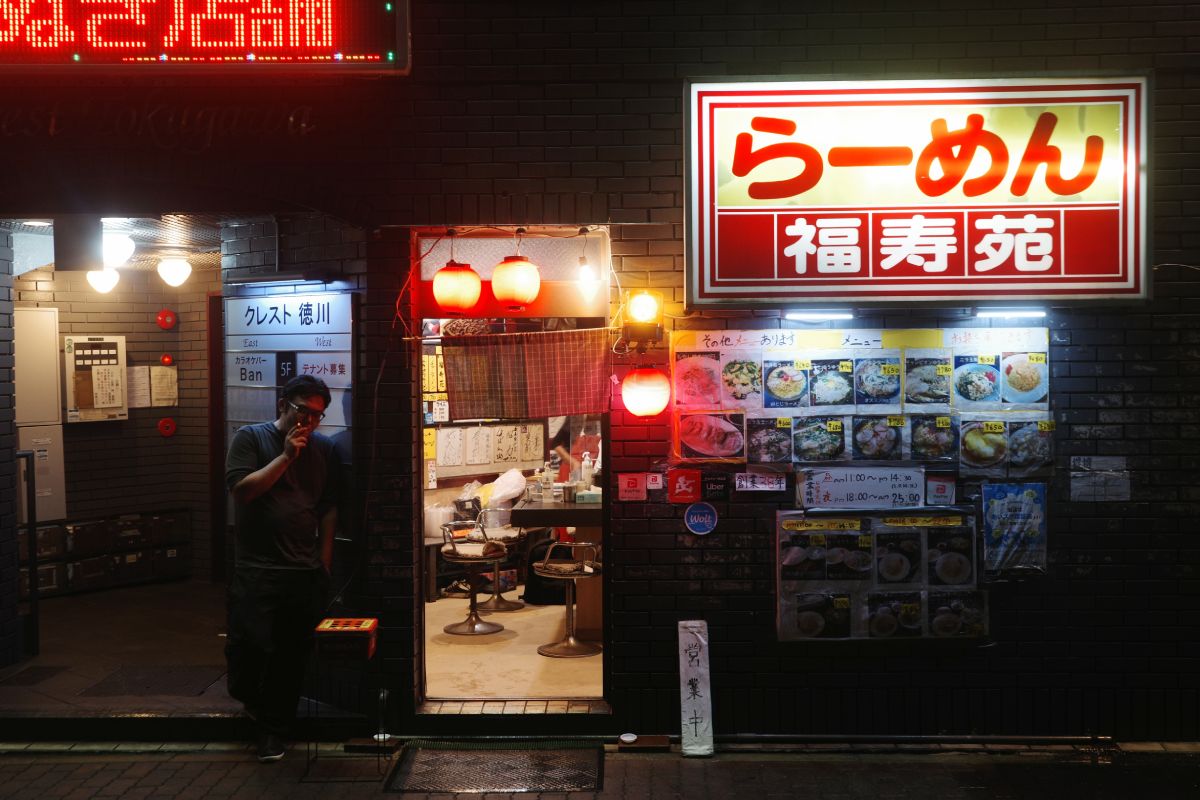 Man standing in front of the hidden gem, Fukujuen, a renowned spot for Ramen in Nagoya.