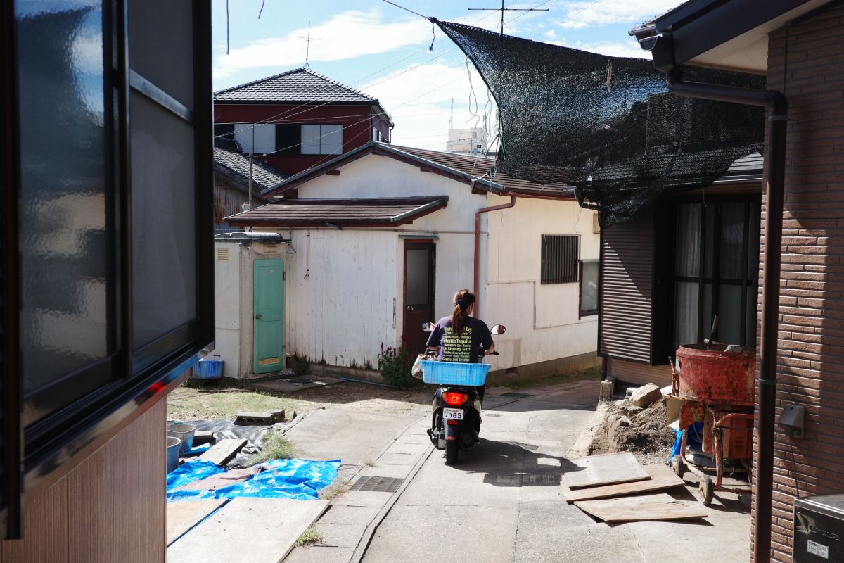 Local Residents Riding Motorcycles on a Narrow Road on Himakajima Island