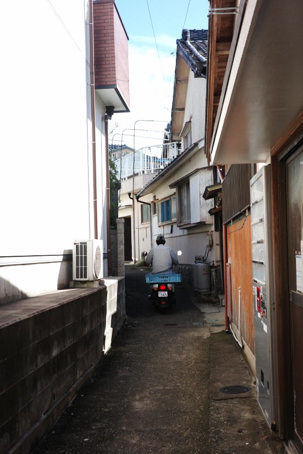 Local Residents Riding Motorcycles on a Narrow Road on Himakajima Island