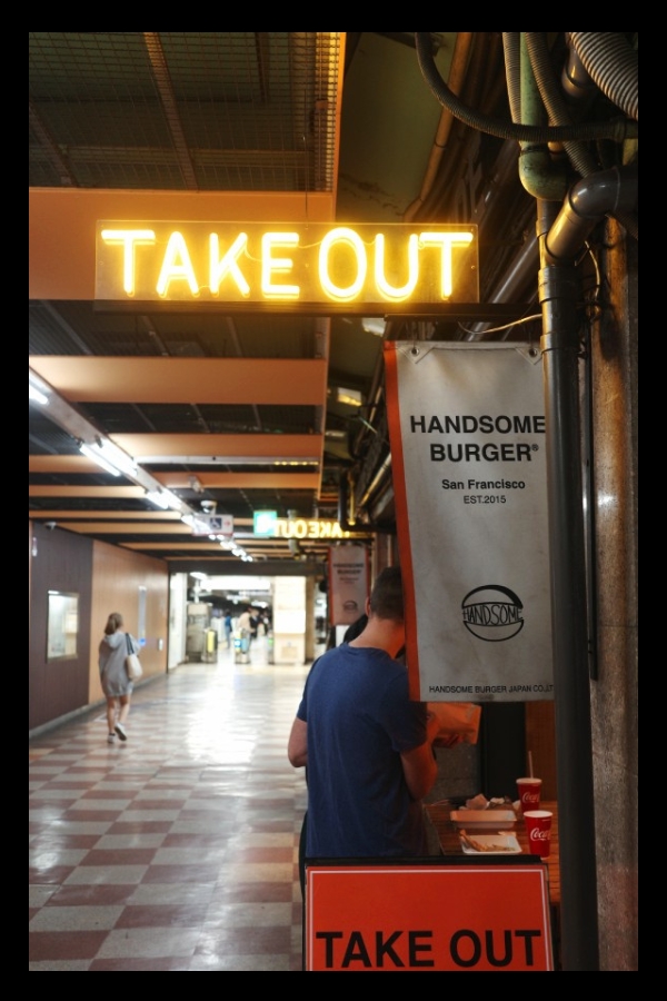 A couple enjoying a meal outside Handsome Burger Handsome one of the best burgers in Nagoya located in the Fushimi Underground Shopping Street in Nagoya.