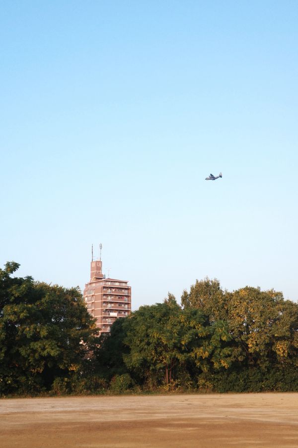 Military aircraft flying over Nagoya Airfield near Daikou Park by the Yada River.