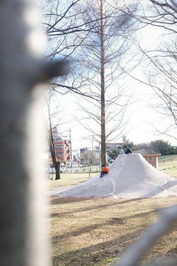 Joyful kids playing at the iconic Mt. Fuji Slide in Kasadera Park, Nagoya.