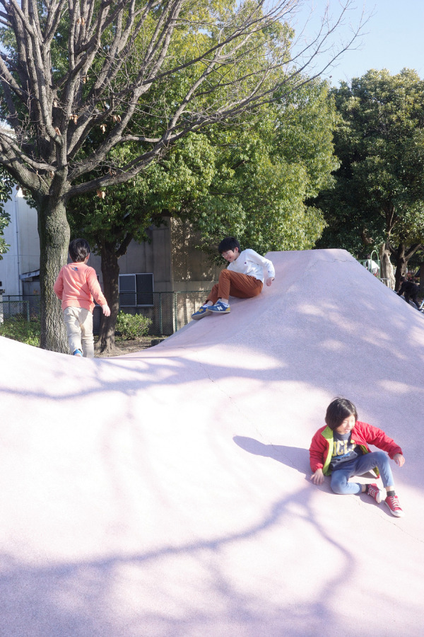 Children enjoying the unique Mt. Fuji slide at Oseko Park, nestled along the scenic Hori River near Atsuta Shrine.