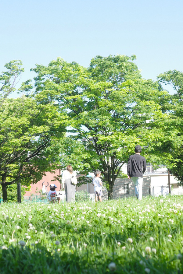 Families enjoying a sunny day amidst the greenery at Tomita Park, a beloved local spot in Nagoya.