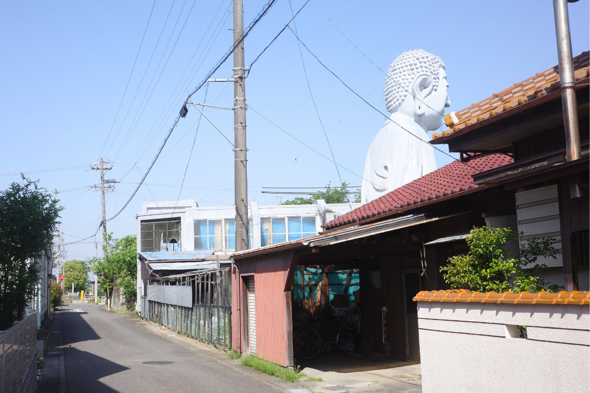 The Great Buddha at Hotei looming large behind residential houses.