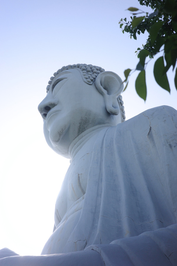 The Great Buddha at Hotei as viewed from behind, looking majestic against the sky.