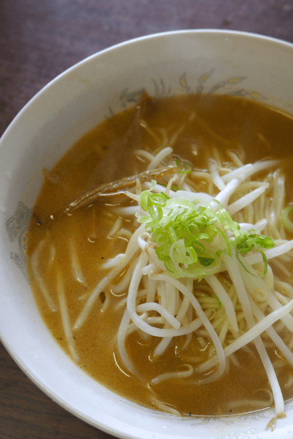 A steaming bowl of miso ramen at Rien, Nagoya's hidden gem. The rich broth is topped with fresh bean sprouts and green onions, offering a delightful flavor