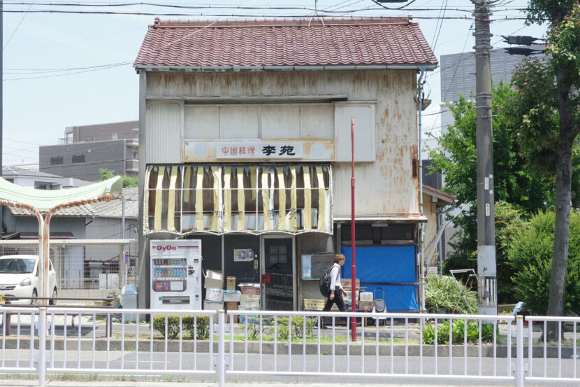 The unassuming exterior of Rien, a hidden gem in Nagoya. Despite its worn-out awning and rustic look, this Chinese restaurant offers incredible flavors inside.