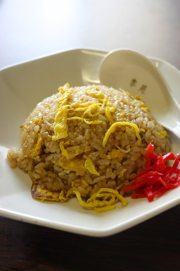 Delicious fried rice at Rien, a hidden gem in Nagoya. The dish features aromatic rice, garnished with strips of egg and a side of pickled ginger.