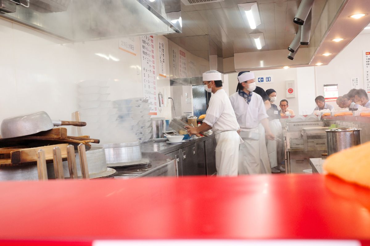 he steam-filled kitchen of Ramen Fuku, showcasing the behind-the-scenes of this hidden gem of ramen in Nagoya.