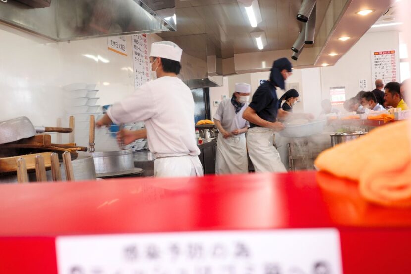 Chefs working in the open kitchen of Ramen Fuku, a hidden gem of ramen in Nagoya, where the culinary action is on full display.